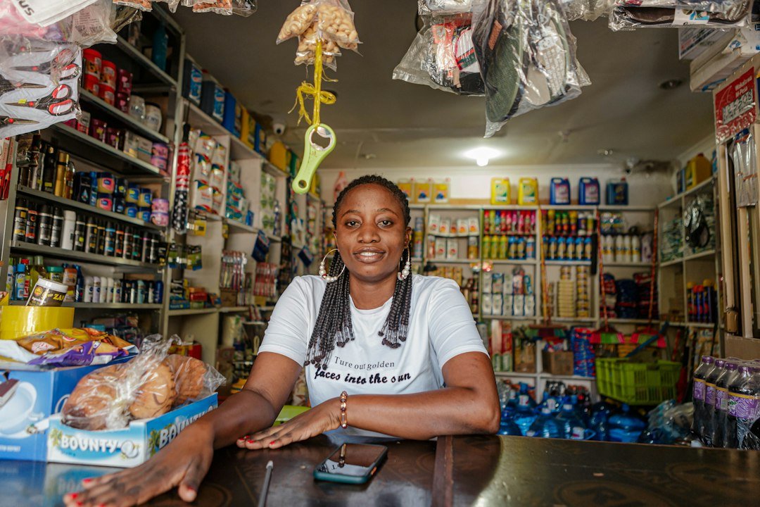 Local shop owner at the store counter, a small business that benefits from Google Business Profile optimization
